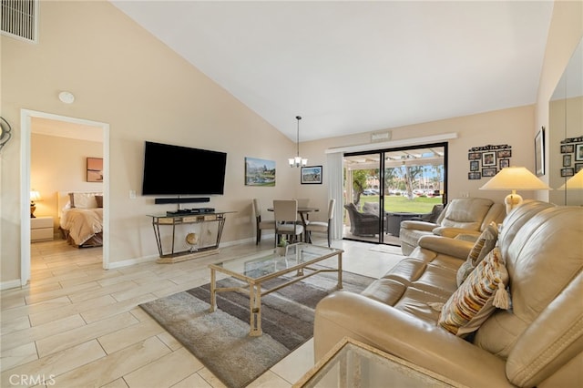 living room featuring an inviting chandelier and high vaulted ceiling