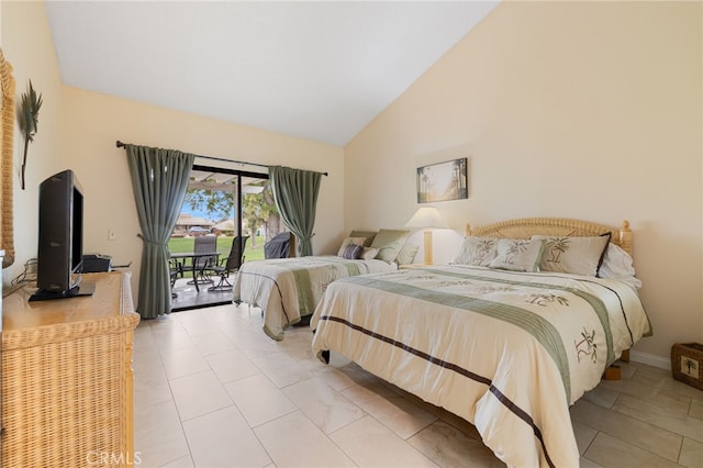 tiled bedroom with high vaulted ceiling and access to outside