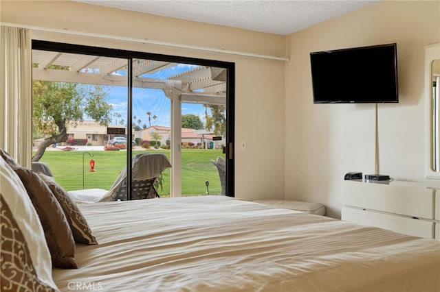 bedroom featuring access to exterior and a textured ceiling