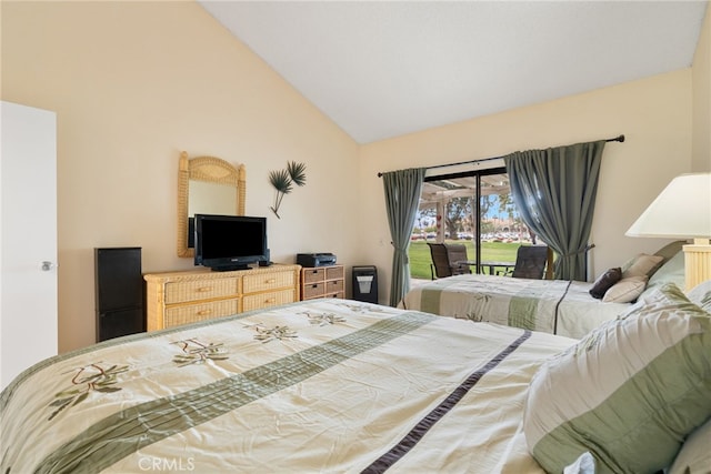 bedroom with lofted ceiling and access to outside