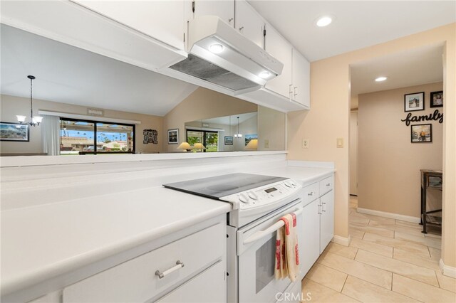 kitchen featuring lofted ceiling, white cabinetry, decorative light fixtures, light tile patterned floors, and electric range