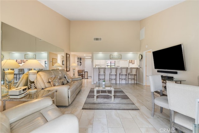 living room featuring a high ceiling