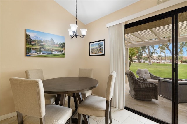 dining area with a water view, lofted ceiling, light tile patterned floors, and a chandelier