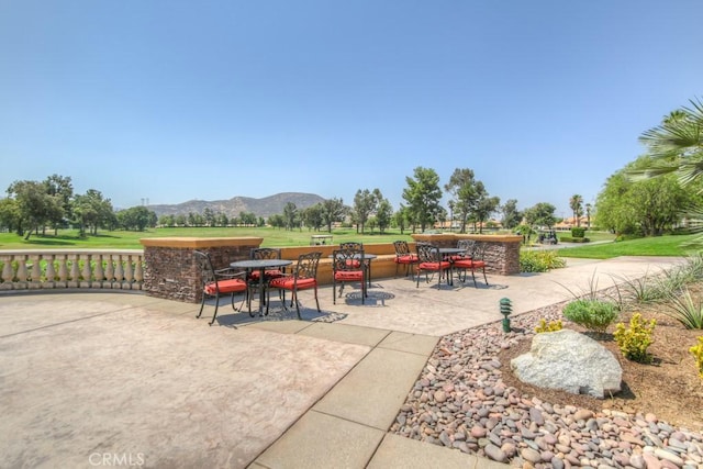 5467 Breckenridge Ave, Banning, CA 92220 - surrounding community with outdoor dining space, a mountain view, and a patio