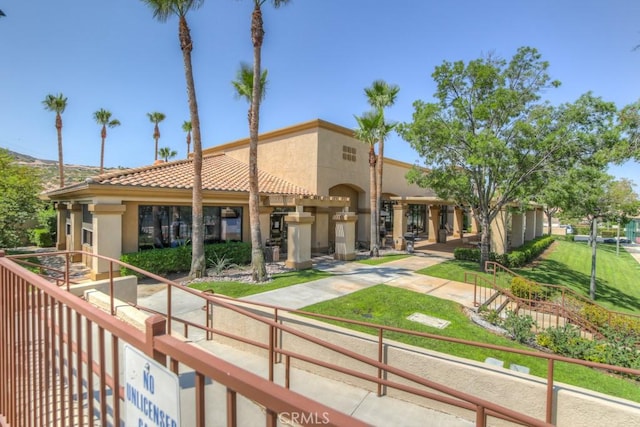 view of front of house featuring a tile roof and stucco siding