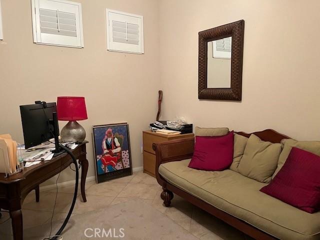 living area with light tile patterned flooring and baseboards