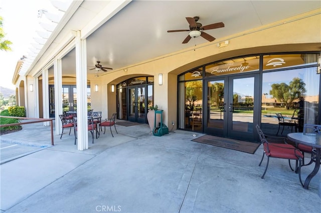 view of patio featuring outdoor dining space, french doors, and ceiling fan