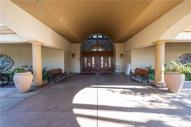 entrance to property with french doors and stucco siding