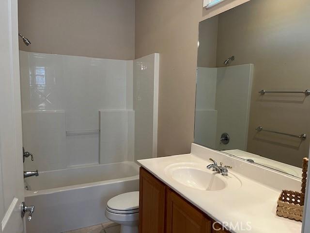 bathroom featuring tub / shower combination, vanity, and toilet