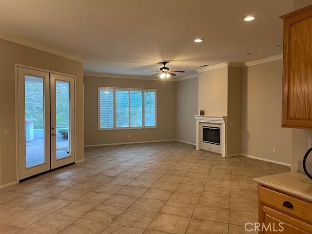 unfurnished living room with french doors, recessed lighting, ornamental molding, a tile fireplace, and baseboards