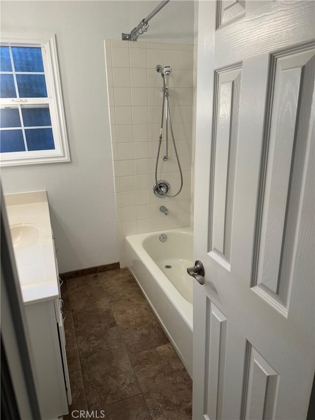 bathroom with tiled shower / bath and vanity