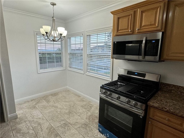 kitchen featuring crown molding, a chandelier, light tile patterned floors, dark stone countertops, and stainless steel appliances