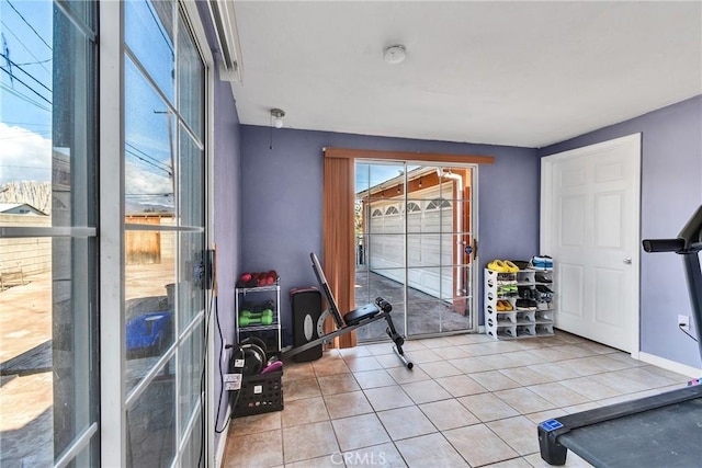 workout room featuring light tile patterned floors