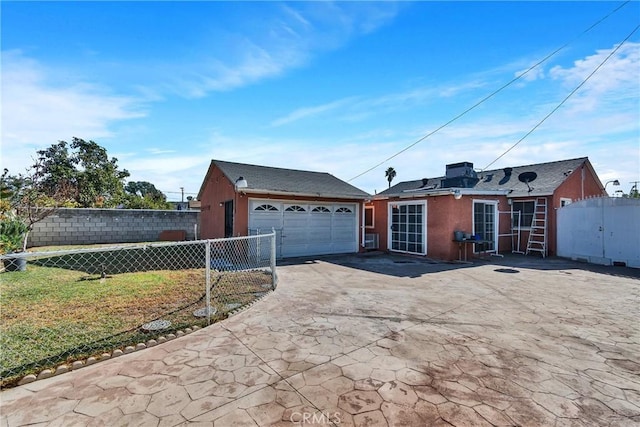 ranch-style home with a garage and a front lawn