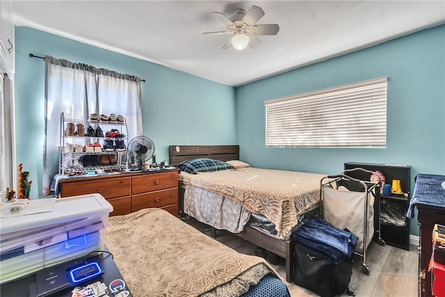 bedroom with hardwood / wood-style floors and ceiling fan