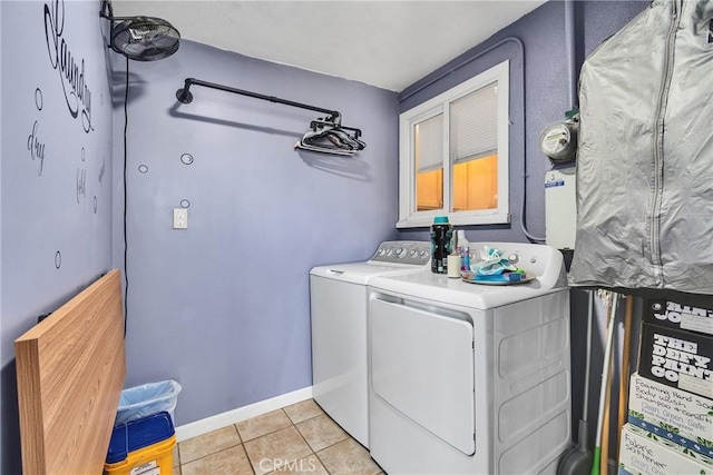 laundry area with washing machine and dryer and light tile patterned floors