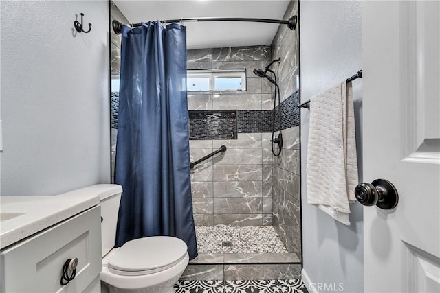 bathroom featuring vanity, tile patterned flooring, toilet, and walk in shower