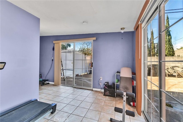 exercise area featuring vaulted ceiling and light tile patterned floors