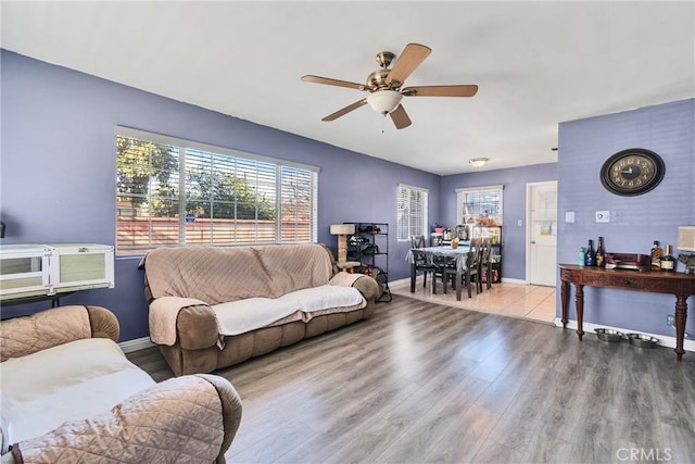 living room featuring ceiling fan and light hardwood / wood-style floors