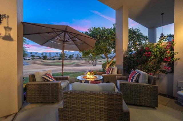 patio terrace at dusk featuring a fire pit