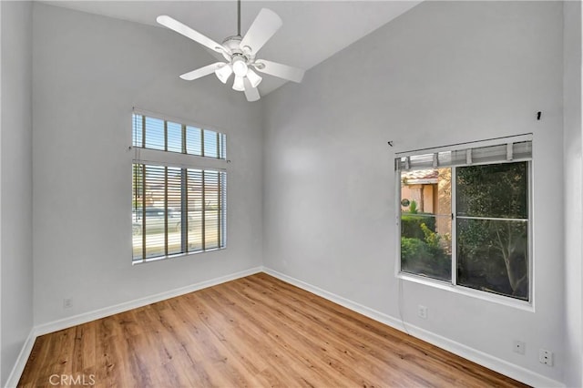 spare room with lofted ceiling, light hardwood / wood-style floors, and ceiling fan