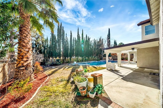 exterior space with ceiling fan and a patio area