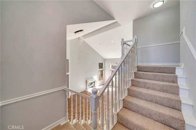 staircase featuring vaulted ceiling