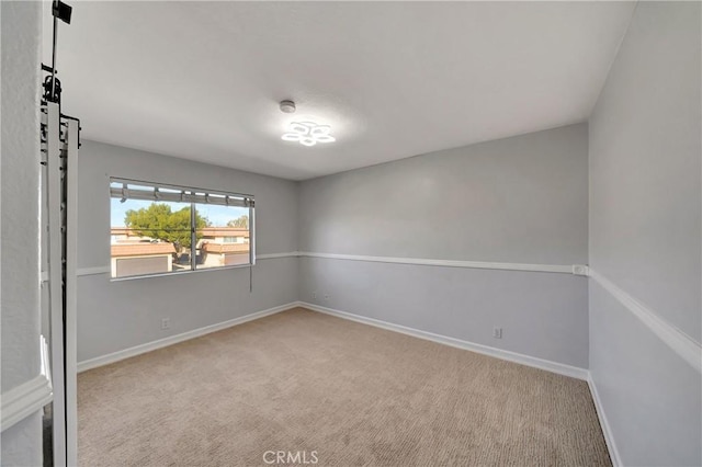 unfurnished room with light carpet