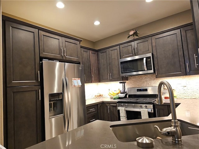 kitchen featuring tasteful backsplash, dark brown cabinetry, and stainless steel appliances