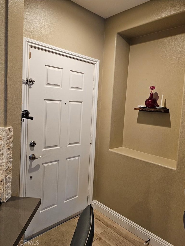 doorway with light wood-type flooring