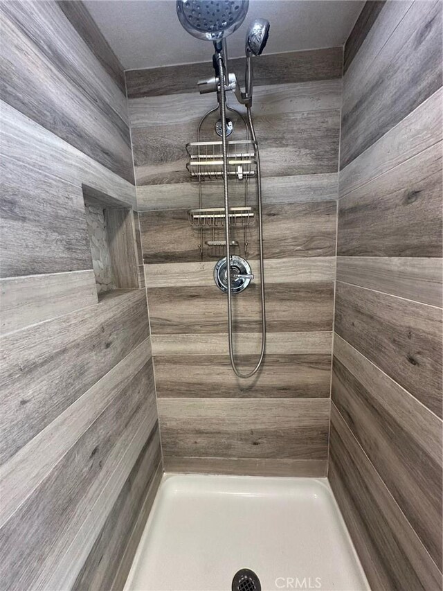 bathroom with a tile shower