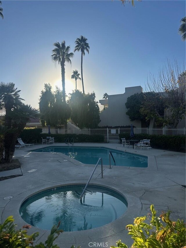 view of pool with a community hot tub and a patio area