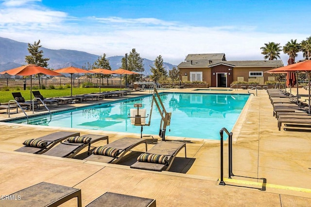 view of swimming pool with a mountain view and a patio