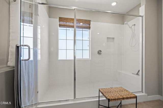 bathroom with tile patterned flooring and a shower with door