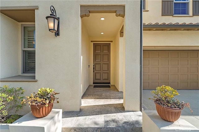 view of exterior entry with a garage