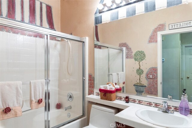 bathroom featuring vanity and combined bath / shower with glass door