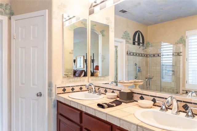 bathroom featuring vanity and an enclosed shower