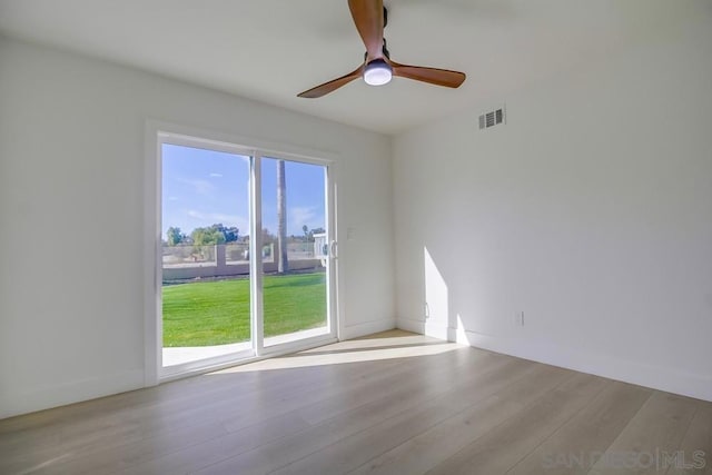 spare room featuring ceiling fan and light hardwood / wood-style flooring