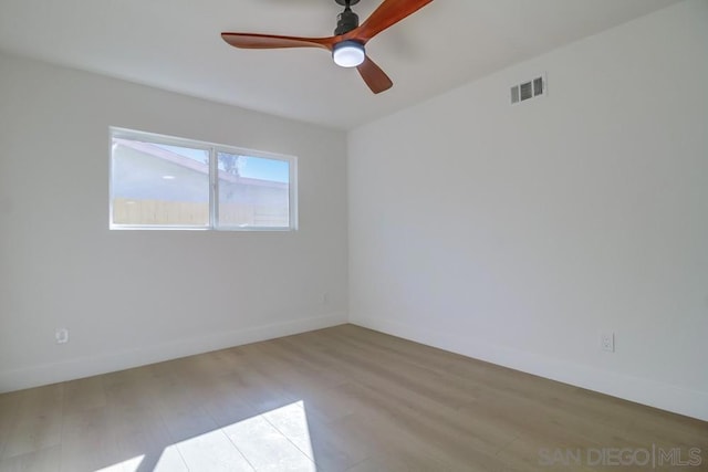 empty room featuring light hardwood / wood-style flooring and ceiling fan