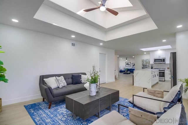 living room featuring ceiling fan and light wood-type flooring