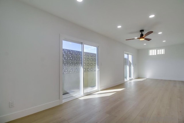 empty room with light hardwood / wood-style floors and ceiling fan