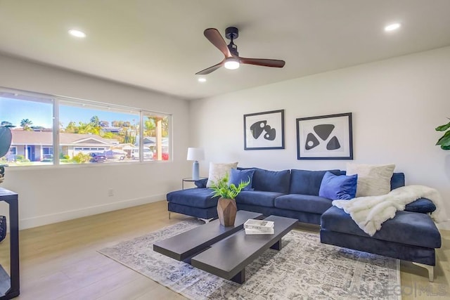 living room with ceiling fan and light wood-type flooring