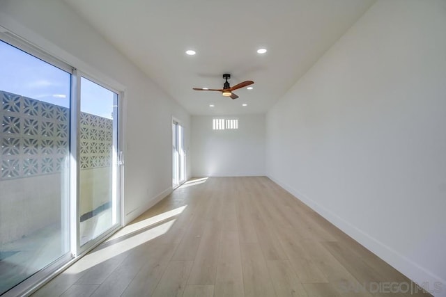 spare room featuring ceiling fan and light wood-type flooring