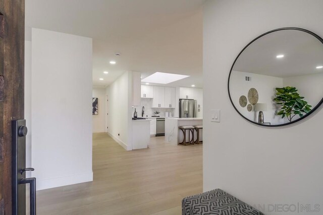 hallway featuring light wood-type flooring