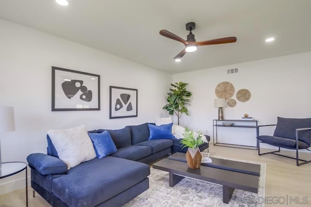 living room with ceiling fan and light wood-type flooring