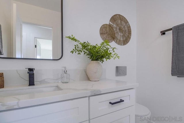 bathroom featuring vanity and toilet