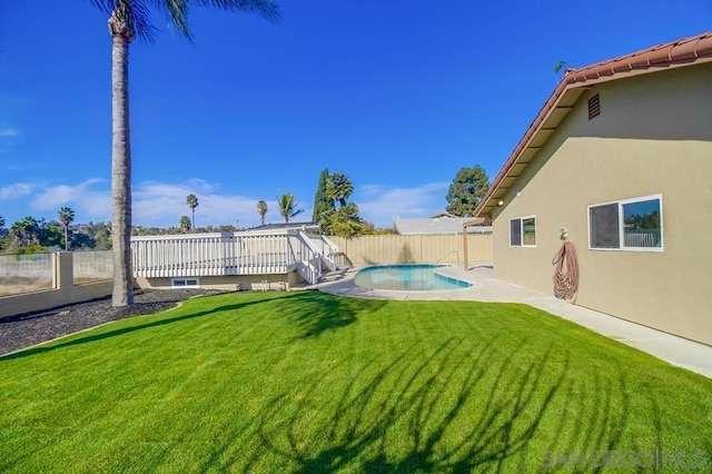 view of yard with a pool side deck