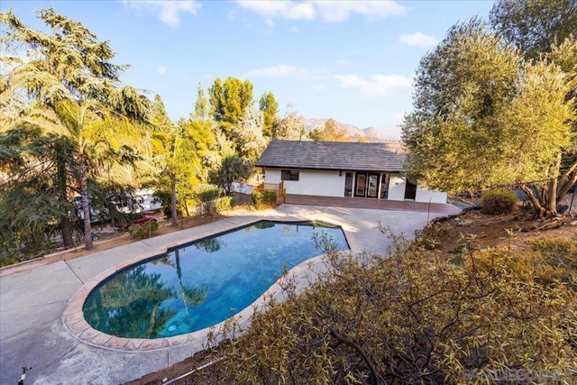 view of pool with a mountain view and a patio area