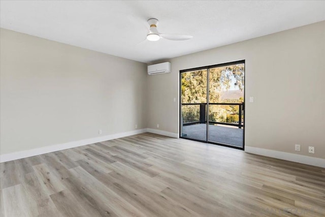 empty room with ceiling fan, light hardwood / wood-style floors, and a wall unit AC