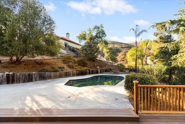 view of swimming pool with a mountain view and a patio